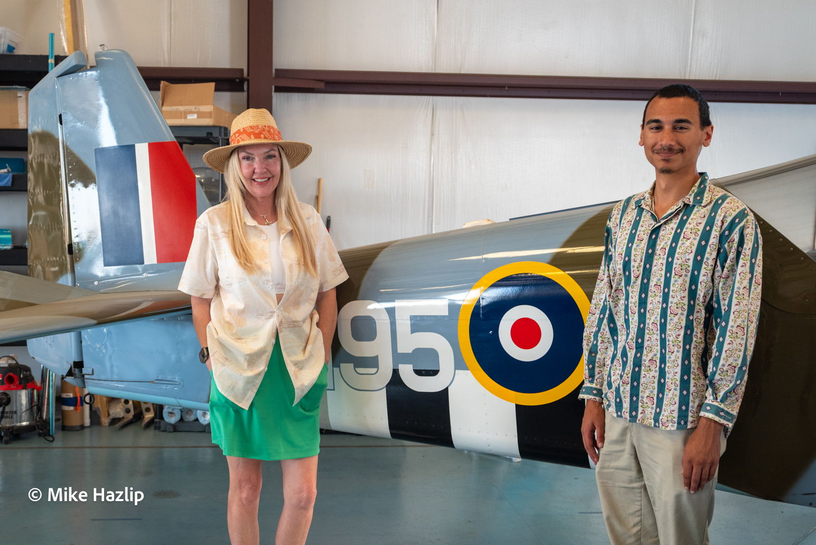 Mary Wick and Hayden Meads stand with Spitfire Aviation's RV-6A painted in WWII British Spitfire livery.